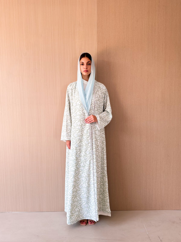 Zainah cut abaya with lace on front in off white with green leaf