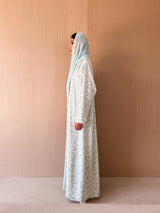 Zainah cut abaya with lace on front in off white with green leaf