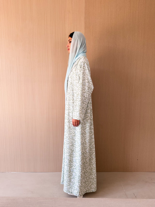Zainah cut abaya with lace on front in off white with green leaf